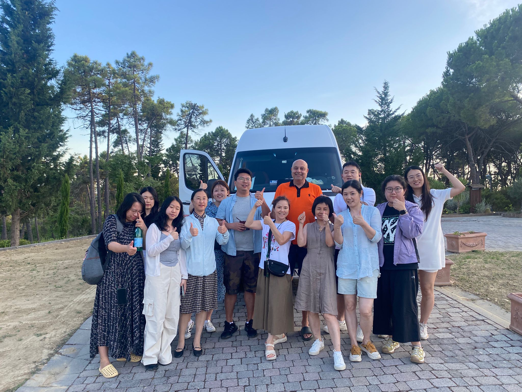 Happy group next to Vaffe Invest minibus